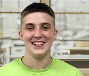 servpro employee with short hair and a green tshirt