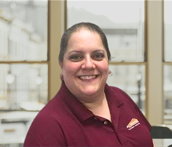 woman with brown hair pulled back and red shirt