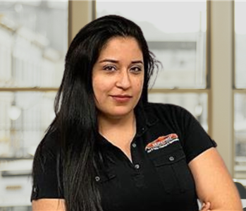 woman with long brown hair and servpro shirt