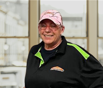 woman with servpro shirt on and a hat