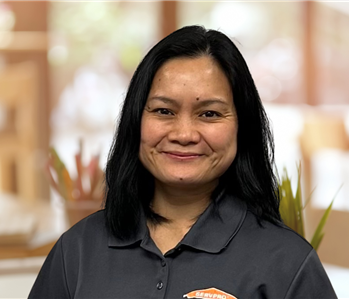 Woman with shoulder length hair and servpro shirt