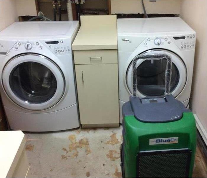 laundry room with SERVPRO machine in it 