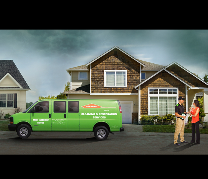 house with servpro van out front