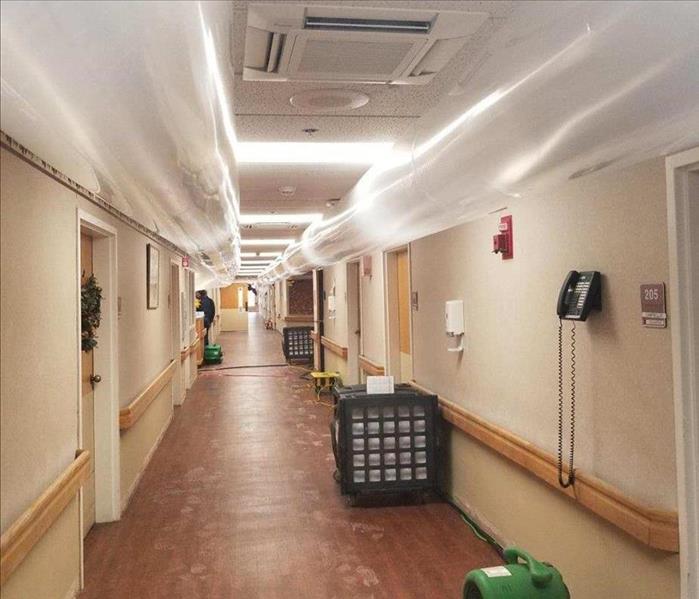 long hallway in nursing home with ventilation ducts set up