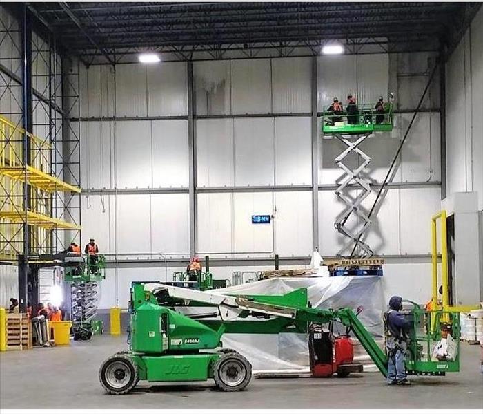 warehouse with servpro crew cleaning 